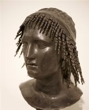 Ancient Greek bust, evoking the mythology of Icarus and Dionysus tied to Ikaria